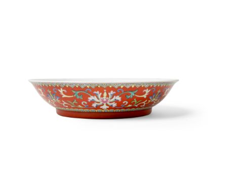 RUBY-RED-GROUND FAMILLE ROSE 'LOTUS AND BAT' PLATE QING DYNASTY, QIANLONG MARK BUT 19TH CENTURY 清 乾隆款 珊瑚紅地粉彩番蓮紋五福捧壽盤 supporte