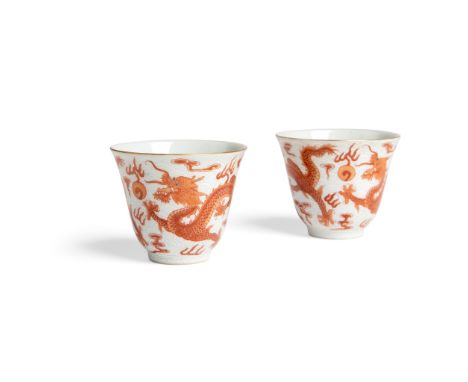 PAIR OF IRON-RED-DECORATED 'DRAGON' CUPS QIANLONG MARK BUT 19TH-20TH CENTURY 十九至二十世紀 乾隆款 白地軋道礬紅彩雙龍趕珠紋杯一對 each thinly potted w