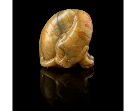 CELADON JADE WITH RUSSET SKIN CARVING OF A TIGER MING DYNASTY, 17TH CENTURY 明 青玉帶皮雕虎形擺件 carved in the round in seated pose, i