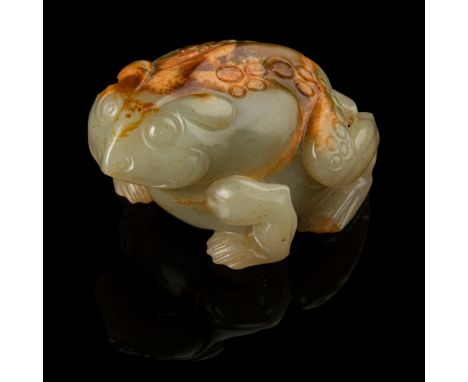 CELADON JADE WITH RUSSET SKIN CARVING OF A TOAD MING DYNASTY, 17TH CENTURY 明 青玉帶皮雕蟾蜍擺件 naturalistically carved in the round w