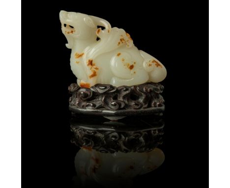 WHITE JADE WITH RUSSET SKIN CARVING OF A MYTHICAL WINGED ANIMAL QING DYNASTY, 18TH-19TH CENTURY 清 白玉帶皮雕翼獸擺件 帶木座 carved in the