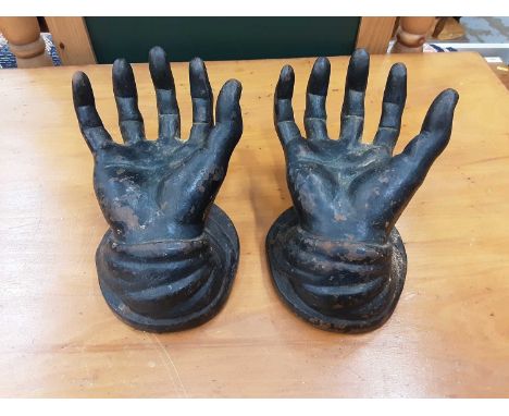 Pair of cast iron hands, cast iron plaque inset with Portuguese ceramic tile, cast iron plaque depicting military band instru