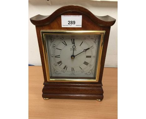 Modern Comitti of London mantel clock in mahogany case with arched top, on four brass feet, 23cm highCondition report: Minor 