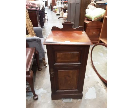 Edwardian walnut pot cupboard, 41cm wide, 86cm high, 37cm deep, and a mahogany framed oval bevelled wall mirror