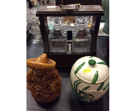 Two bottle tantalus together with two ceramic storage jars (3)