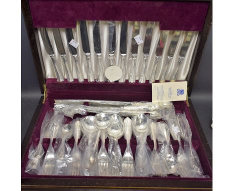 A six setting canteen of cutlery with carving set, K Bright, Sheffield, Dubbary pattern, cased, unused