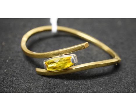 A 9ct gold yellow stone twisting hinge bangle, 12.4g gross