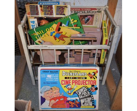 A Chad Valley Walt Disney cine projector, complete in box; a mid 20th Century doll's cot; a doll making set, boxed; etc