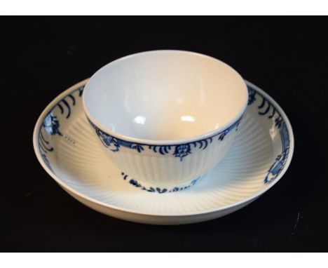 A Worcester reeded tea bowl and saucer, painted in blue with flower spray within a formal border, crescent marks, c.1760 Prov