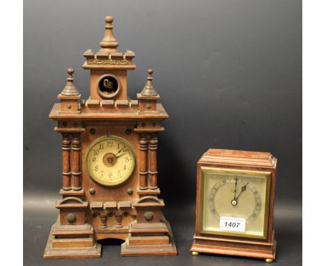 A German Cuckoo clock, architectural turreted case, open aperture, cream dial, twin bellows movement; another smaller Elliott