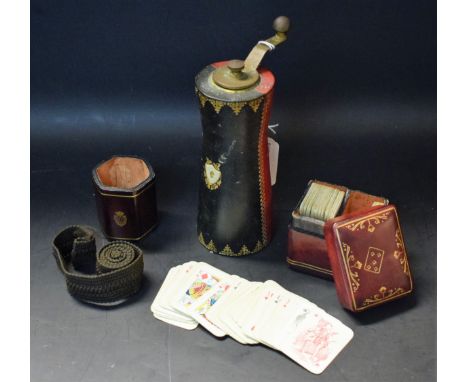 An Italian red tooled leather miniature playing cards case, with cards; a leather dice shaker and pepper mill (3)
