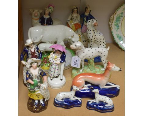 Ceramics - a pair of Staffordshire male and female figures; a Staffordshire figure of a hound; others, similar (11)