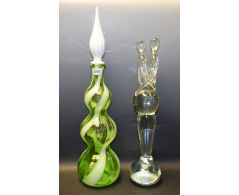 A Murano clear glass sculpture, two entwined figures; a 1960's spiral glass bottle vase, in tones of green, white glass stopp