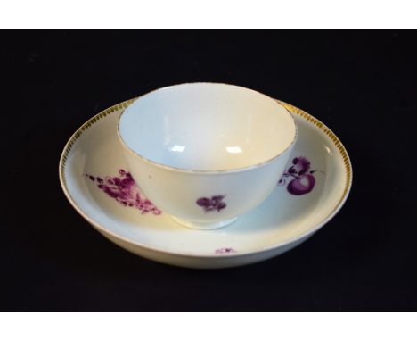 A Worcester tea bowl and saucer, decorated in the James Giles style with cut and whole fruit in purple monochrome, gilt rims,