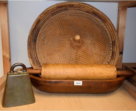 A 19th century wooden trencher, 60cm long; a brass cow bell, James Barwell, Birmingham; a large wooden rolling pin; a large c