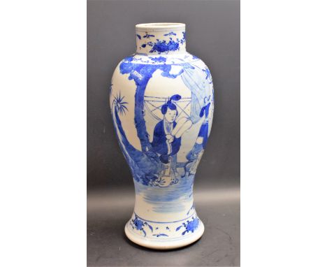 A Chinese baluster vase, painted in tones of underglaze blue with figures at a table laid with precious objects, 30.5cm high,