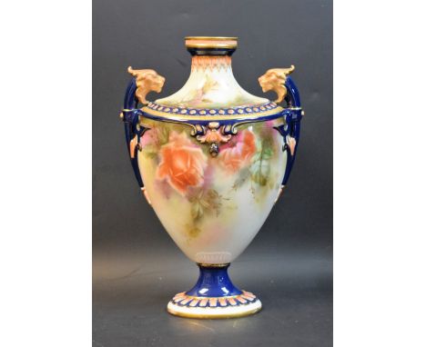 A Hadleys Worcester pedestal ovoid vase, decorated with roses, lion masks flying handles, beaded border, stiff leaves to neck