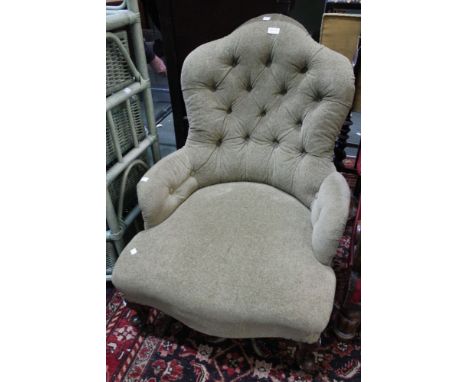 A late Victorian button back salon chair, with carved cabriole fore supports in green fabric