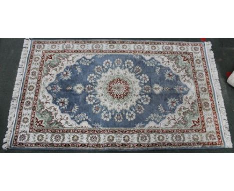 A Persian design pale blue ground rug, with floral decoration, fringed &amp; bordered, 153cm x 94cm