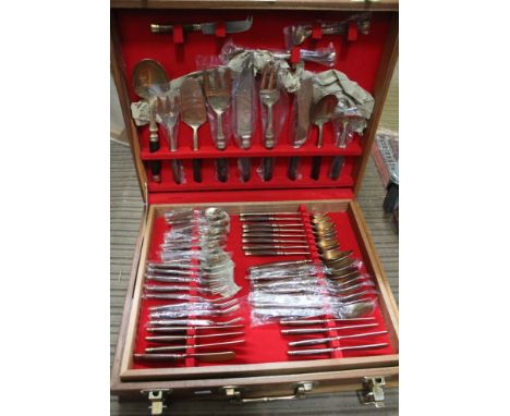 A Far Eastern bronze cutlery set, having teak handles, approx 100 pieces, cased