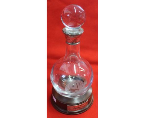 A silver collar glass decanter with stopper, engraved "Ancient and Masonic Order Scarlet Cord" sitting within a turned mahoga