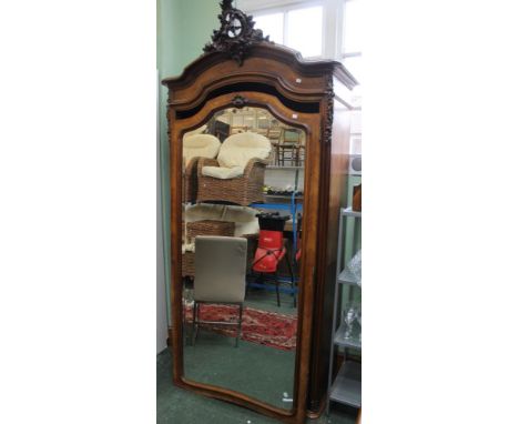 A late 19th century French armoire walnut veneer wardrobe, carved crest, single door fitted bevel plate mirror, 222cm high  