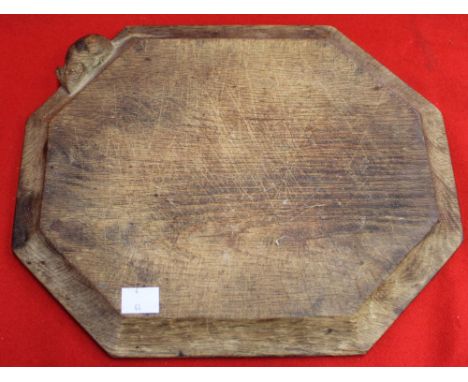 Robert Thompson of Kilburn (1876-1955) "Mouseman" an oak bread board of canted rectangular form with carved trademark mouse t