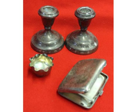 A silver cigarette case, small silver bowl and a pair of loaded silver candlesticks, weighable silver 88g