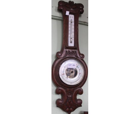 A wall hanging barometer / thermometer