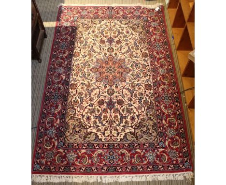 A Persian design rug, pink and blue on a central cream ground, fringed and bordered 172cm x 111cm Condition: condition good, 