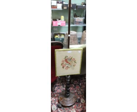 A Victorian rosewood firescreen, the adjustable panel with wool work bird decoration
