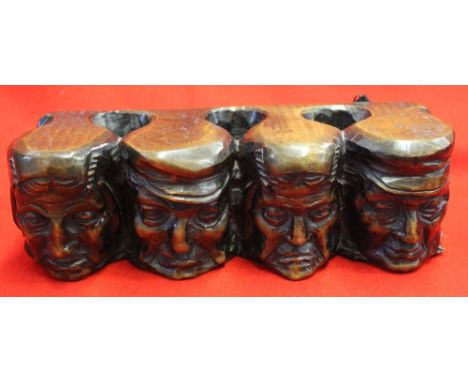A Continental carved wood pipe rack, with mask decoration, 24cm&nbsp;