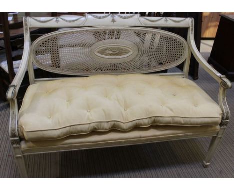 A painted frame open arm sofa, cane panel back fitted with seat pad Dimensions: Width across front of arms 126cm, from back t