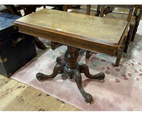 Victorian walnut fold top card table on carved pedestal to four scrolled legs, 70cm by 92cm by 46cm (closed).