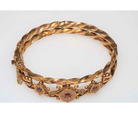 Edwardian 9 carat gold bangle of ornate form and set with three rubies, Chester hallmark 1907.