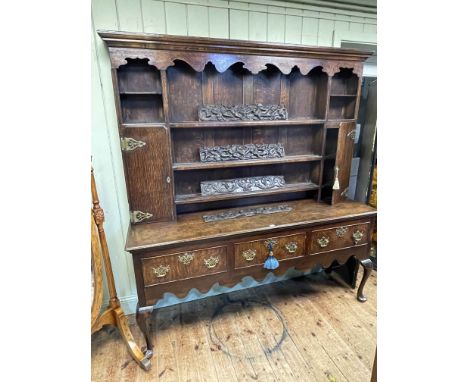 19th Century oak dresser, the shelf back with two cupboard doors above a base of three drawers on cabriole legs, 201cm by 185