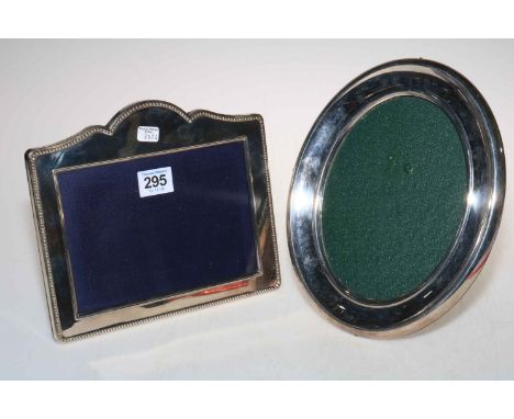 Two large silver easel photograph frames, the oval one 24.5cm high.