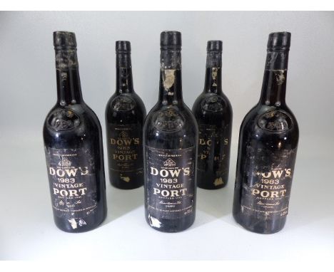 Five bottles of Dow's 1983 Vintage Port. Each bottle in varying condition. 