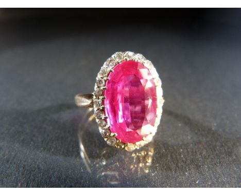 14ct hallmarked vintage ring set with a Synthetic Ruby surrounded by Diamonds. 