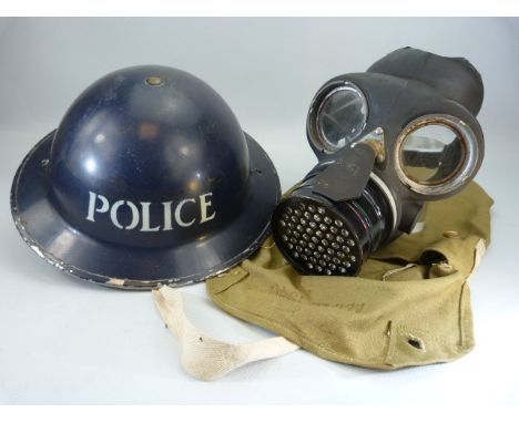 Vintage metal police helmet along with a gasmask dated 9/8/44.