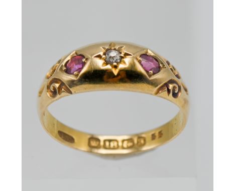 An 18ct ruby and diamond set three stone ring, size M.