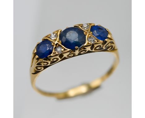 An 18ct sapphire and diamond set three stone ring, size R/S.