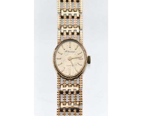 An 9ct yellow gold watch .H Samuel, gate bracelet style, quartz movement , champagne dial .17.5 grams.