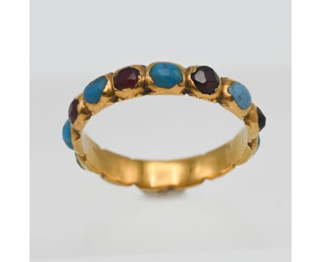 A Georgian turquoise and garnet set band ring (unmarked), size J/K.