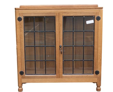 Robert "Mouseman" Thompson (1876-1955), two door display cabinet with leaded glass, c1990s, w.107 x d.35 x h.107cm, with sign