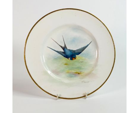 A Royal Worcester cabinet plate by H Powell, painted with a swallow with gilt border, printed blue factory mark, 23cm diamete