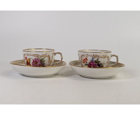 Pair of Berlin KPM cups and saucers, decorated with flowers and insects. (4) 