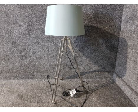 Industrial style floor lamp with blue shade.