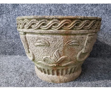 A composite stone garden planter 34cm diameter.