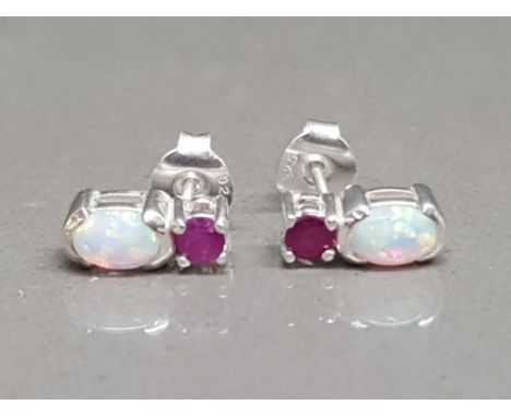 A pair of silver stud earrings set with ruby and opal 2.03g gross